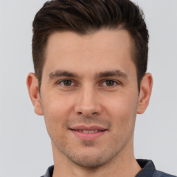 Joyful white young-adult male with short  brown hair and brown eyes