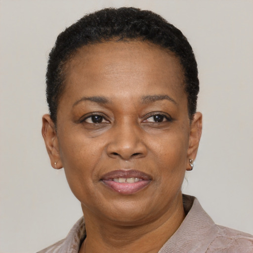 Joyful black adult female with short  black hair and brown eyes