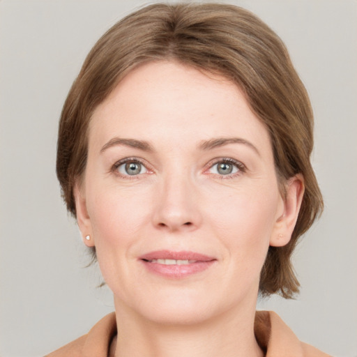 Joyful white young-adult female with medium  brown hair and grey eyes