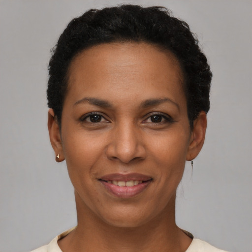 Joyful latino young-adult female with short  brown hair and brown eyes