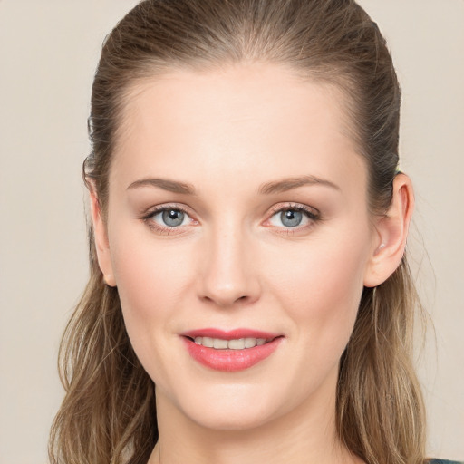 Joyful white young-adult female with long  brown hair and grey eyes