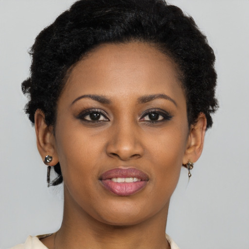 Joyful black young-adult female with short  brown hair and brown eyes