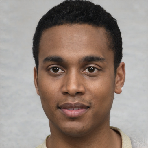 Joyful black young-adult male with short  black hair and brown eyes