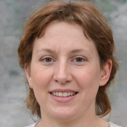 Joyful white adult female with medium  brown hair and brown eyes