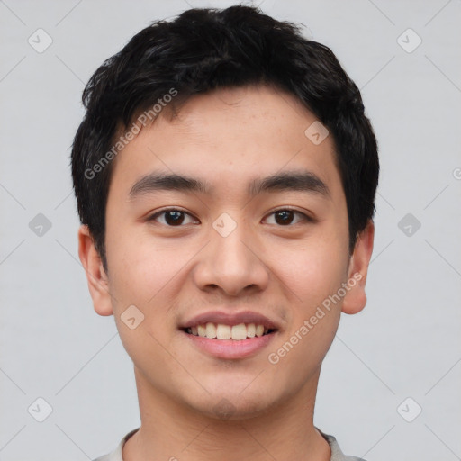 Joyful asian young-adult male with short  black hair and brown eyes