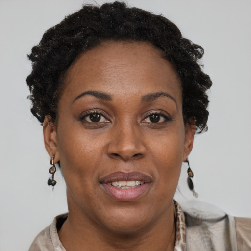 Joyful black adult female with short  brown hair and brown eyes