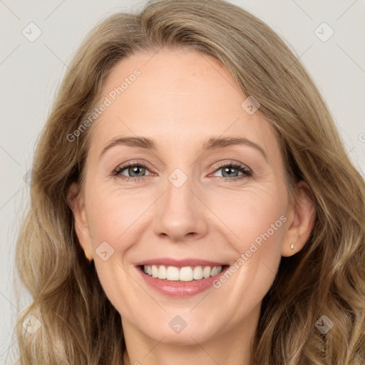 Joyful white young-adult female with long  brown hair and green eyes