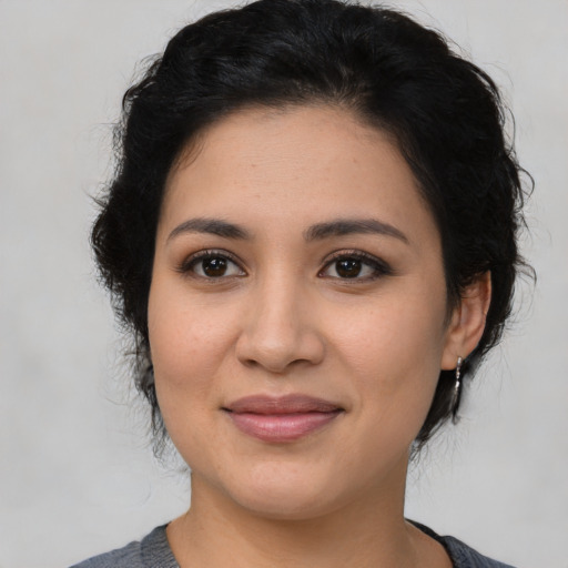 Joyful latino young-adult female with medium  black hair and brown eyes