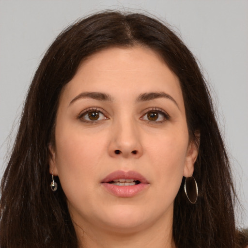 Joyful white young-adult female with long  brown hair and brown eyes