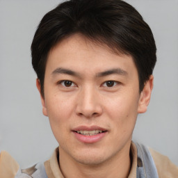 Joyful asian young-adult male with short  brown hair and brown eyes