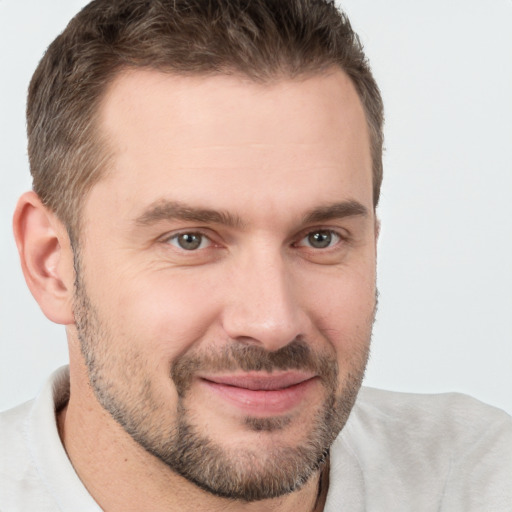 Joyful white adult male with short  brown hair and brown eyes