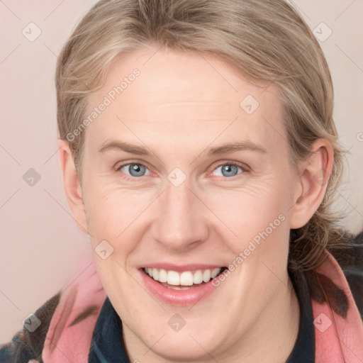 Joyful white adult female with medium  brown hair and blue eyes