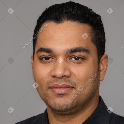 Joyful latino young-adult male with short  black hair and brown eyes