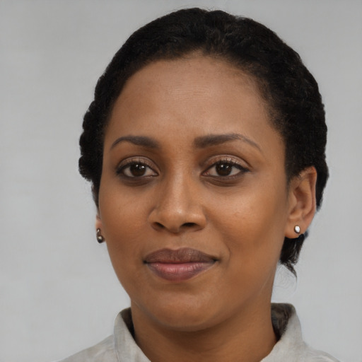Joyful black adult female with short  black hair and brown eyes