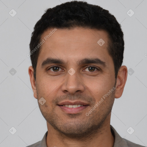 Joyful white young-adult male with short  black hair and brown eyes