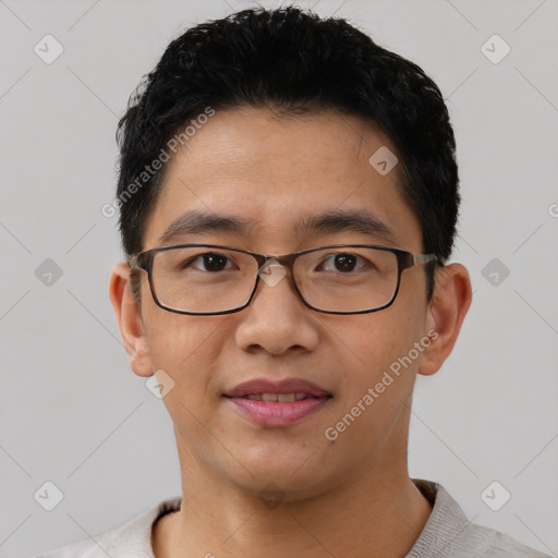 Joyful asian young-adult male with short  black hair and brown eyes