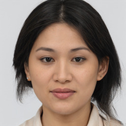 Joyful asian young-adult female with medium  brown hair and brown eyes