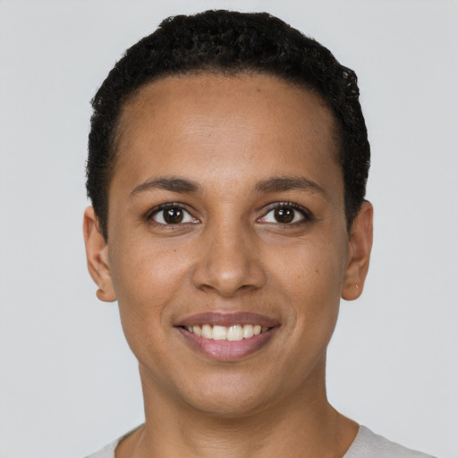 Joyful black young-adult female with short  brown hair and brown eyes