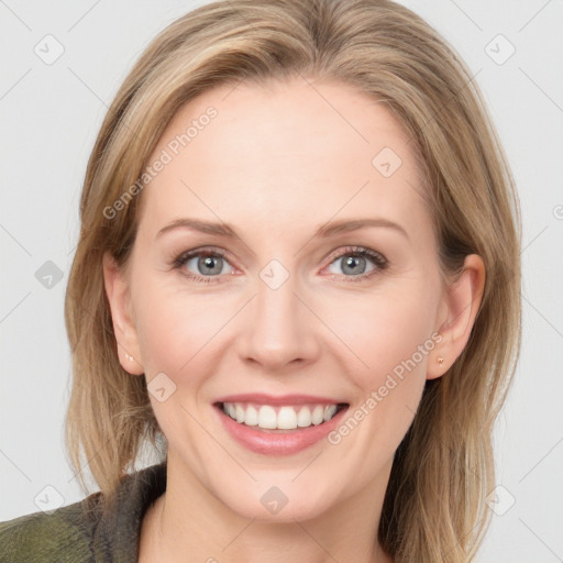 Joyful white adult female with medium  brown hair and blue eyes