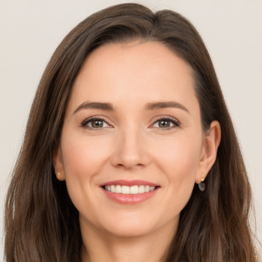 Joyful white young-adult female with long  brown hair and brown eyes