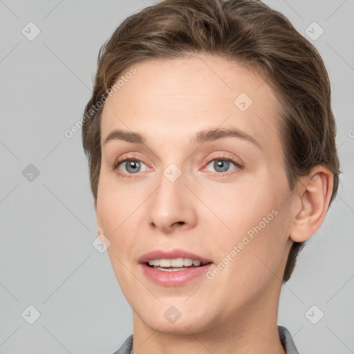 Joyful white young-adult female with short  brown hair and grey eyes