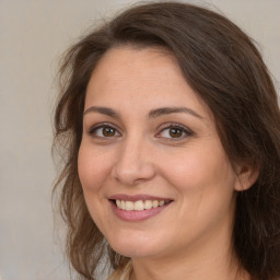 Joyful white adult female with long  brown hair and brown eyes