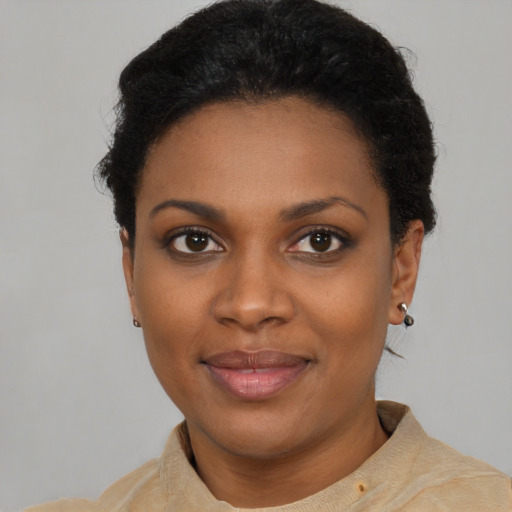 Joyful black young-adult female with short  black hair and brown eyes