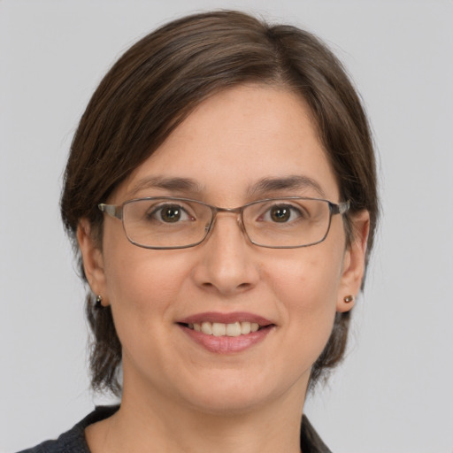 Joyful white adult female with medium  brown hair and grey eyes