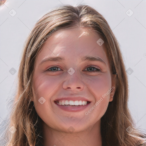 Joyful white young-adult female with long  brown hair and blue eyes