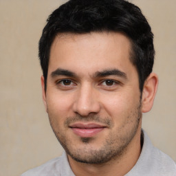 Joyful white young-adult male with short  black hair and brown eyes