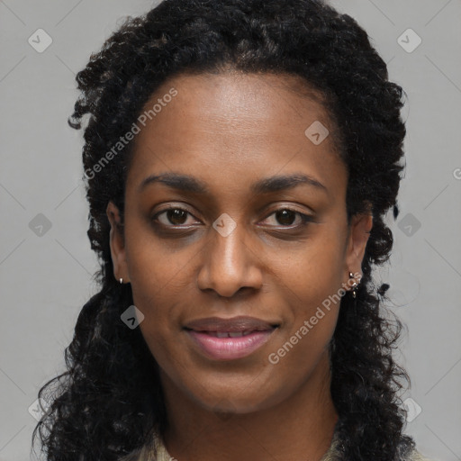 Joyful black young-adult female with long  black hair and brown eyes