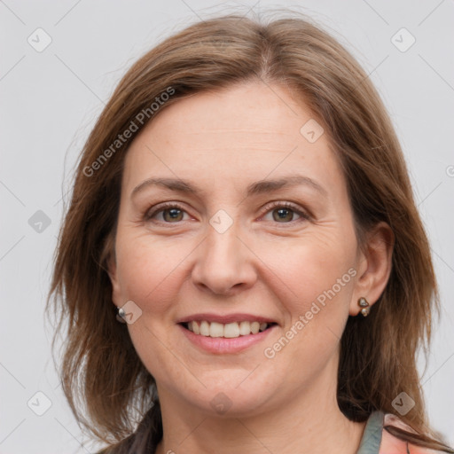 Joyful white adult female with medium  brown hair and grey eyes