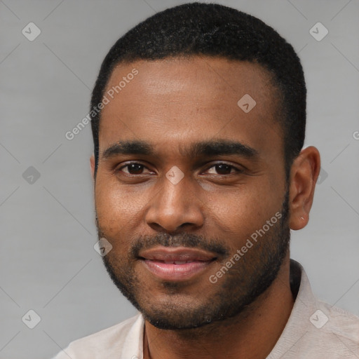 Joyful black young-adult male with short  black hair and brown eyes