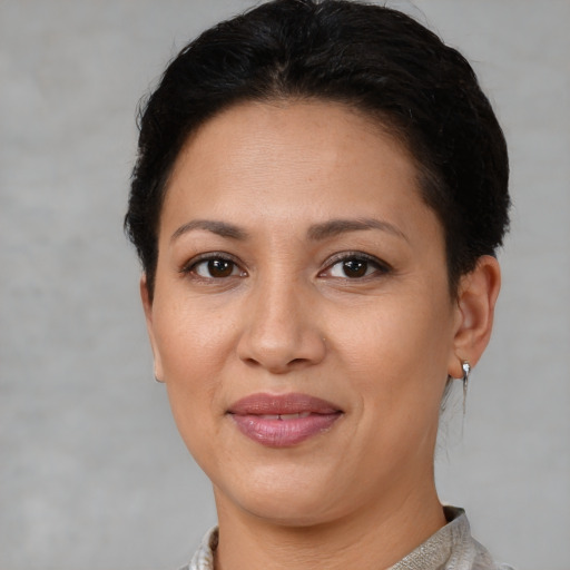 Joyful white adult female with short  brown hair and brown eyes