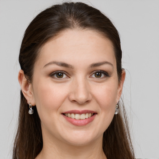 Joyful white young-adult female with long  brown hair and grey eyes