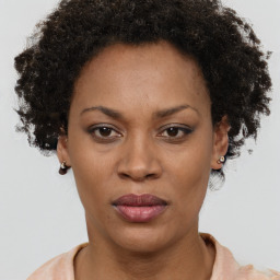 Joyful black adult female with short  brown hair and brown eyes