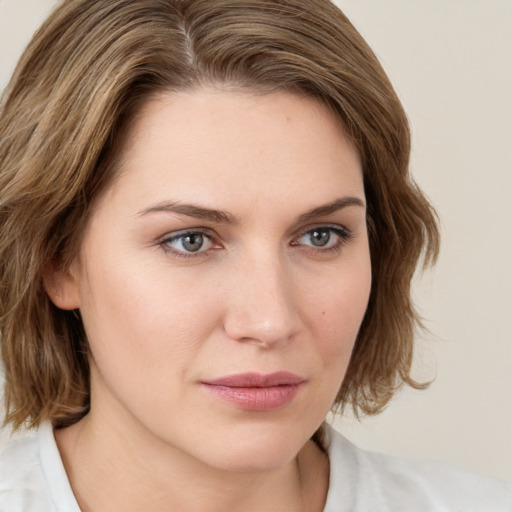 Joyful white young-adult female with medium  brown hair and green eyes