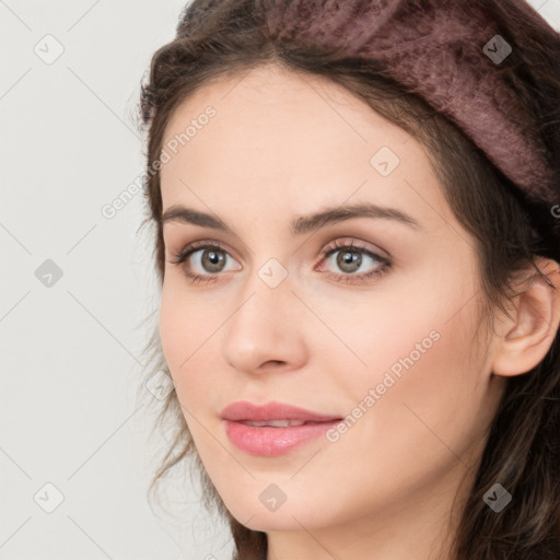 Joyful white young-adult female with long  brown hair and green eyes