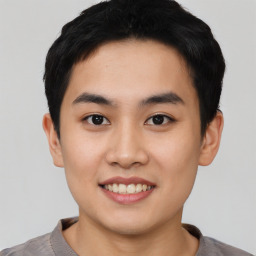 Joyful asian young-adult male with short  black hair and brown eyes