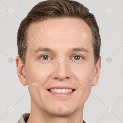 Joyful white young-adult male with short  brown hair and grey eyes