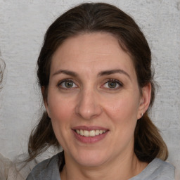 Joyful white adult female with medium  brown hair and brown eyes