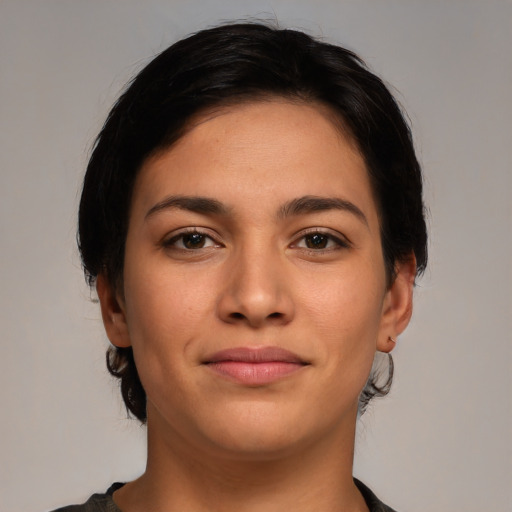 Joyful latino young-adult female with medium  brown hair and brown eyes