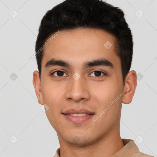 Joyful white young-adult male with short  black hair and brown eyes