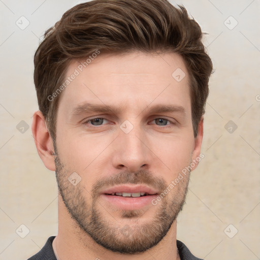 Joyful white young-adult male with short  brown hair and grey eyes