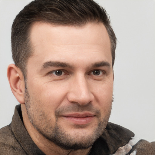 Joyful white adult male with short  brown hair and brown eyes