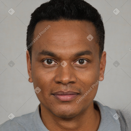 Joyful black young-adult male with short  black hair and brown eyes