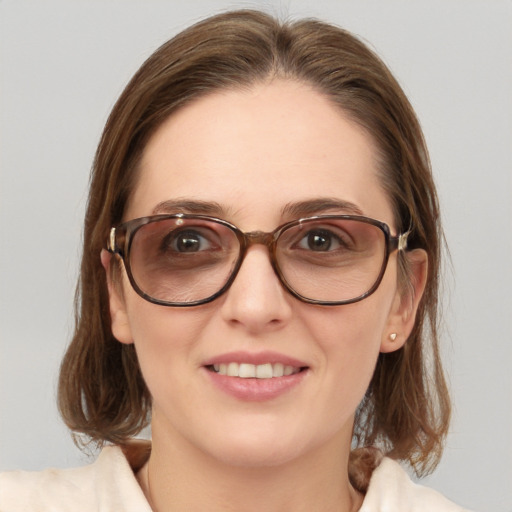 Joyful white young-adult female with medium  brown hair and blue eyes