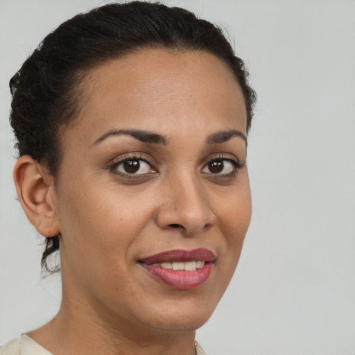 Joyful latino young-adult female with short  brown hair and brown eyes