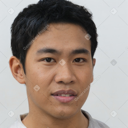 Joyful asian young-adult male with short  black hair and brown eyes