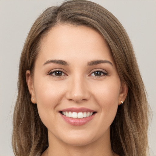 Joyful white young-adult female with long  brown hair and brown eyes